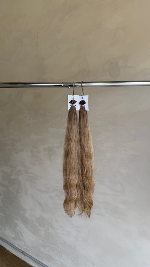  long wavy hair extensions in a light golden blonde shade 