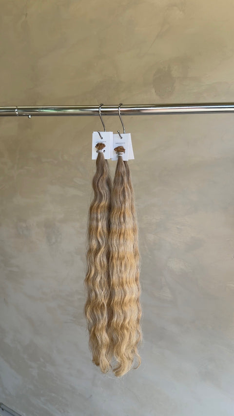 Luxury blonde curly Slavic hair extensions with seamless keratin bonds at a North Lakes salon in North Brisbane