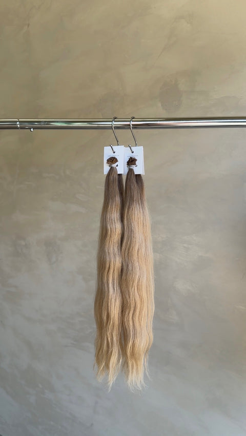 Soft blonde Slavic hair extensions with a natural wave, creating seamless length and volume at a North Lakes salon in North Brisbane